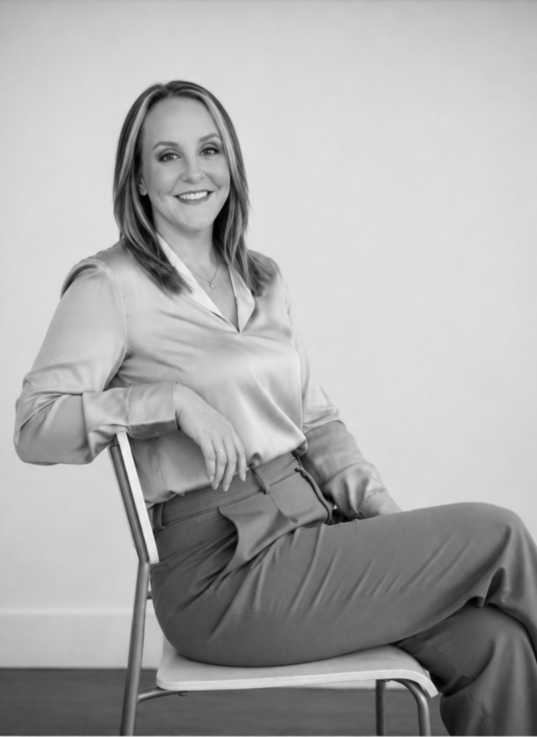 Faith Nance, REALTOR® and founder of FN Home Group, seated portrait in black and white